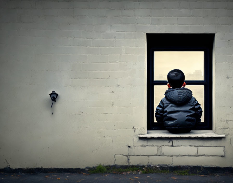 Child in black jacket gazes out open window in white brick wall with lamp