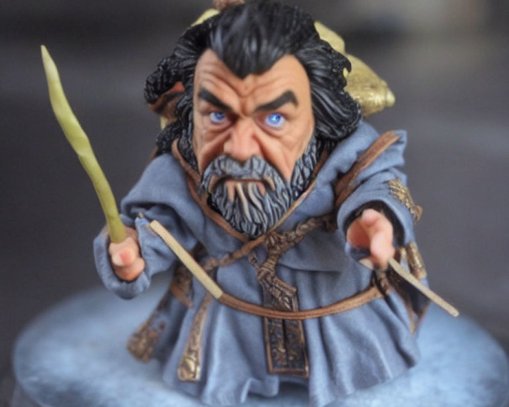 Fierce bearded warrior figurine with spear in blue robe