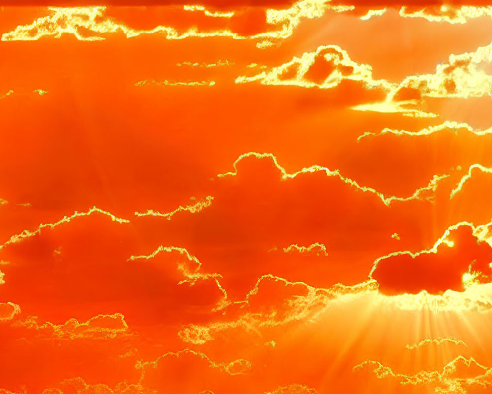 Vibrant Orange and Yellow Sky with Sunrays Through Fluffy Cumulus Clouds