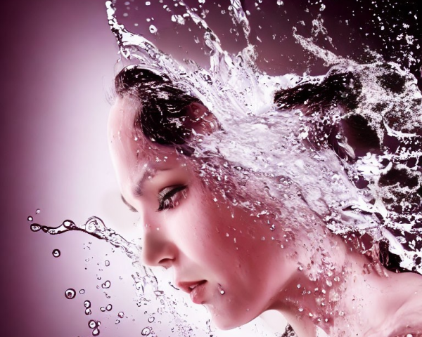 Person profile with water splashing on purple background