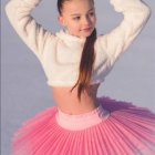 Young Ballerina in Pink Tutu Surrounded by Colorful Paint Strokes