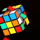 Colorful 3D Rubik's Cube on Reflective Black Surface