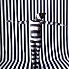 Colorful Striped Dress Woman Against Optical Illusion Background