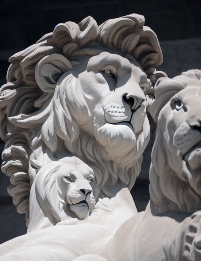 Sculpted white stone lions in varying sizes and detail
