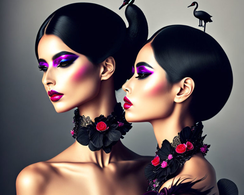 Two women with stylized makeup and swan adornments in an elegant fashion portrait