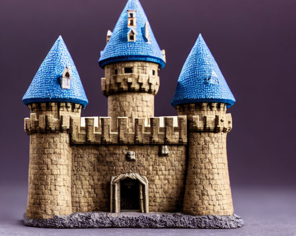 Miniature fairy-tale castle with blue roofs on purple background
