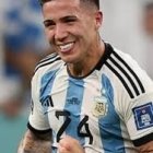 Smiling man with tattoos in football jersey at stadium