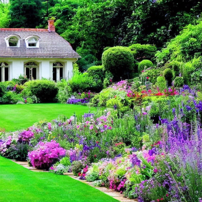 Vibrant flower garden and manicured lawn in front of white house