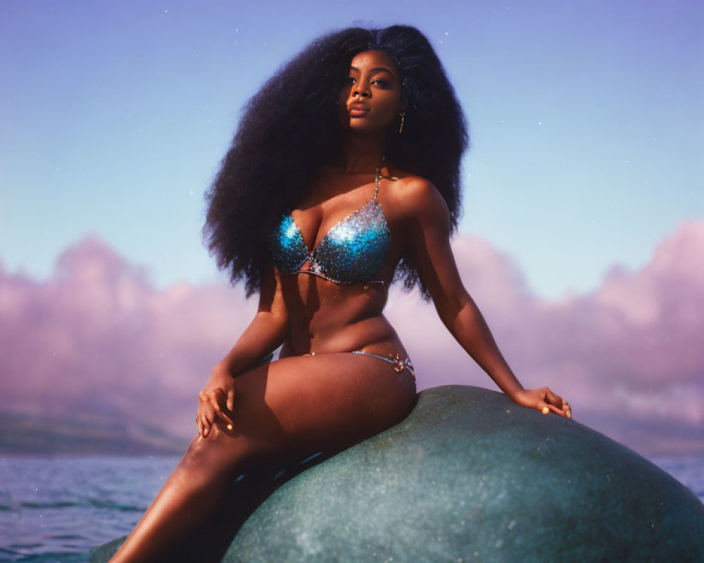 Woman in Sparkly Blue Bikini Poses on Rock by Misty Waters