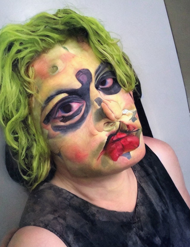 Abstract Picasso-style face paint with multiple eyes and lips, neon green hair