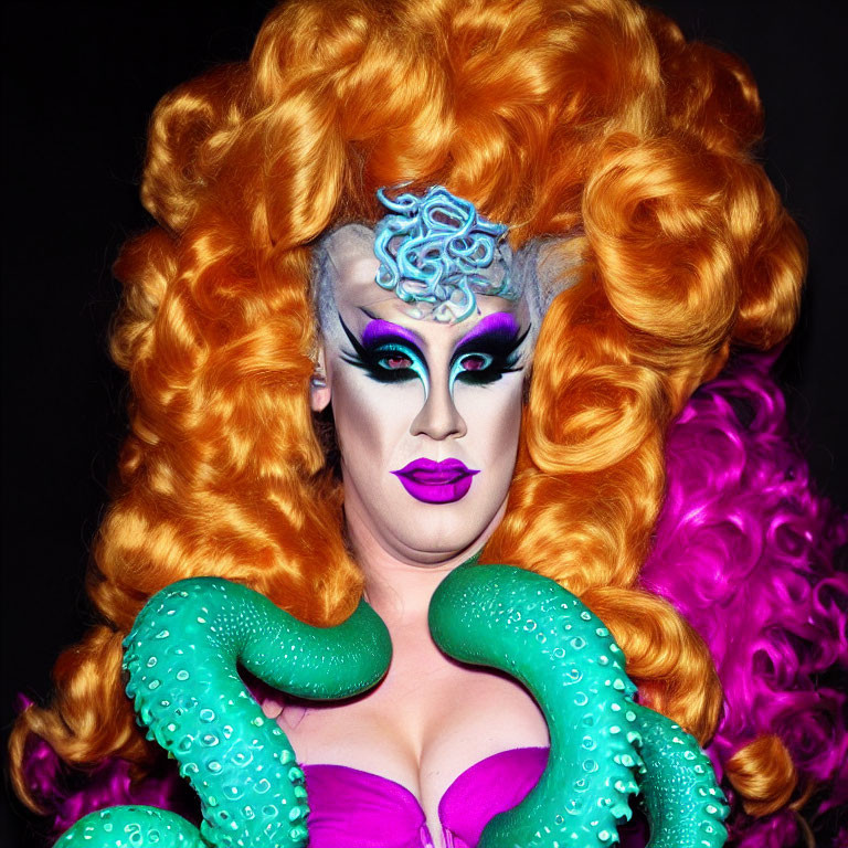 Person in orange wig and tentacle costume with dramatic makeup