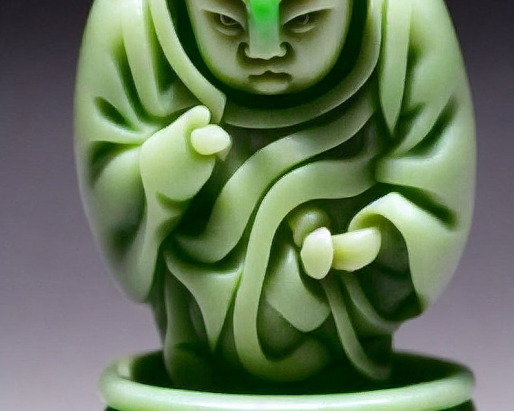 Detailed Green Jade Carving of Figure with Intense Gaze and Elaborate Drapery