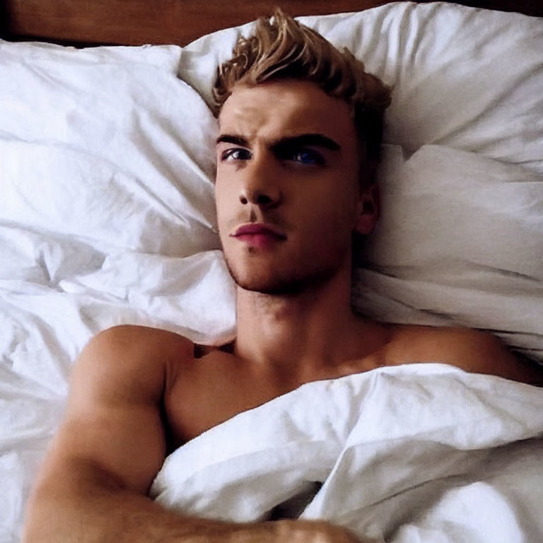 Blond Young Person Lying Shirtless in Bed