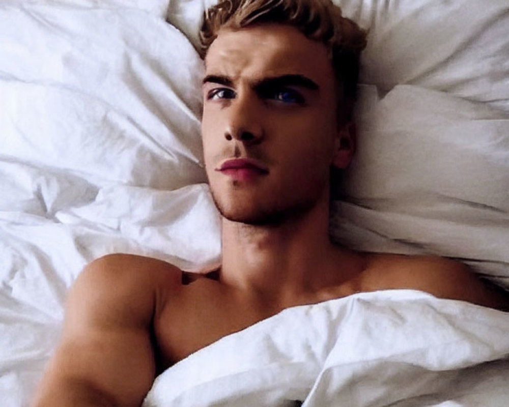 Blond Young Person Lying Shirtless in Bed