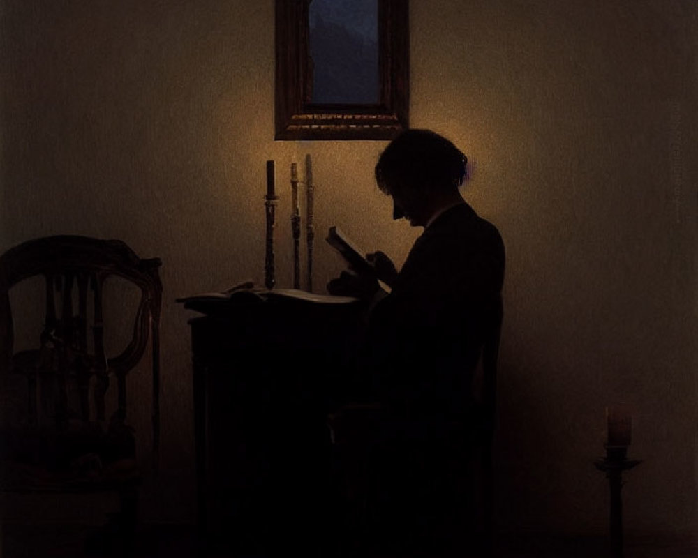 Silhouetted figure reading by candlelight in dark room