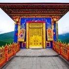 Colorful Floral Archway with Mountainous Backdrop and Cloudy Sky