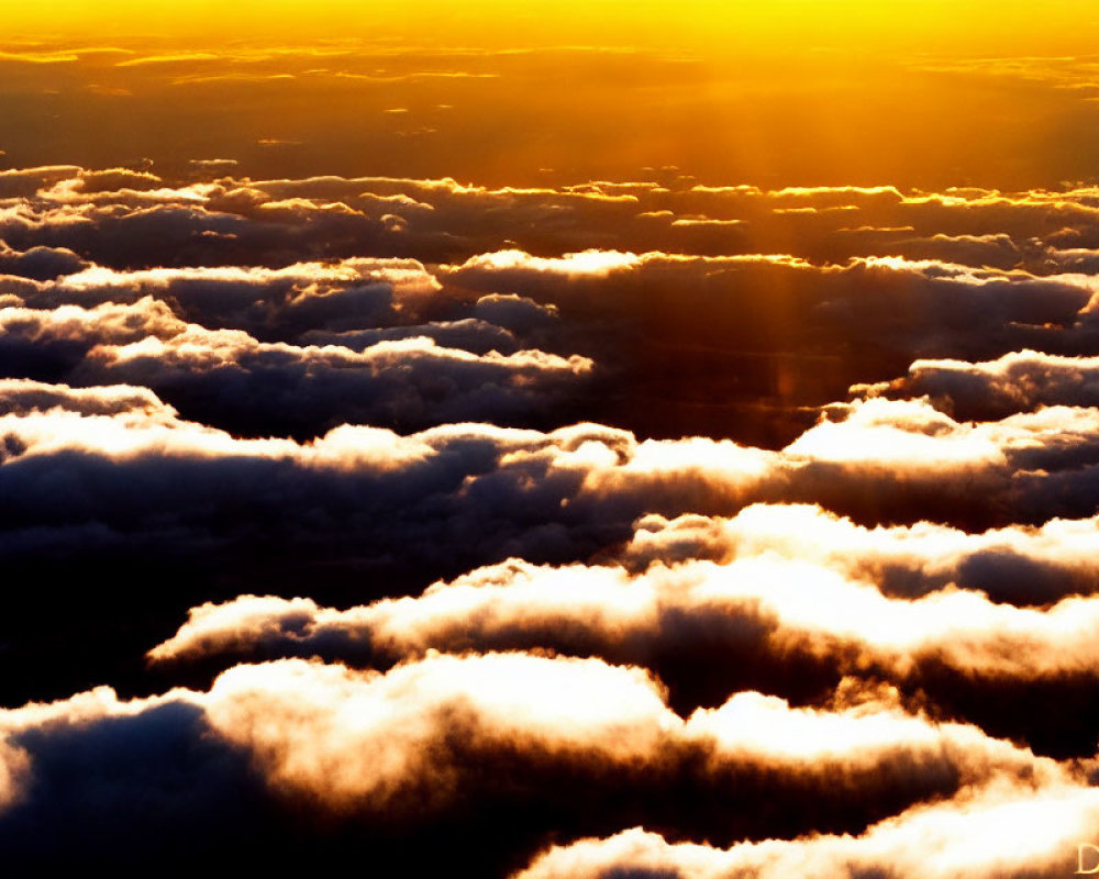 Golden sunlight illuminates dramatic cloudscape in vibrant hues