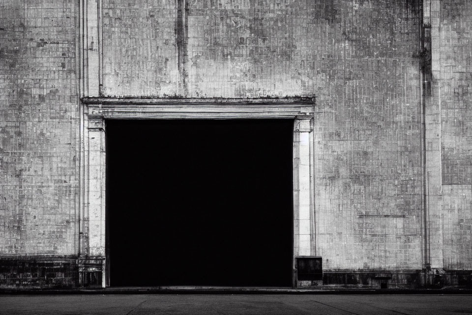 Black and White Photo of Weathered Industrial Doorway