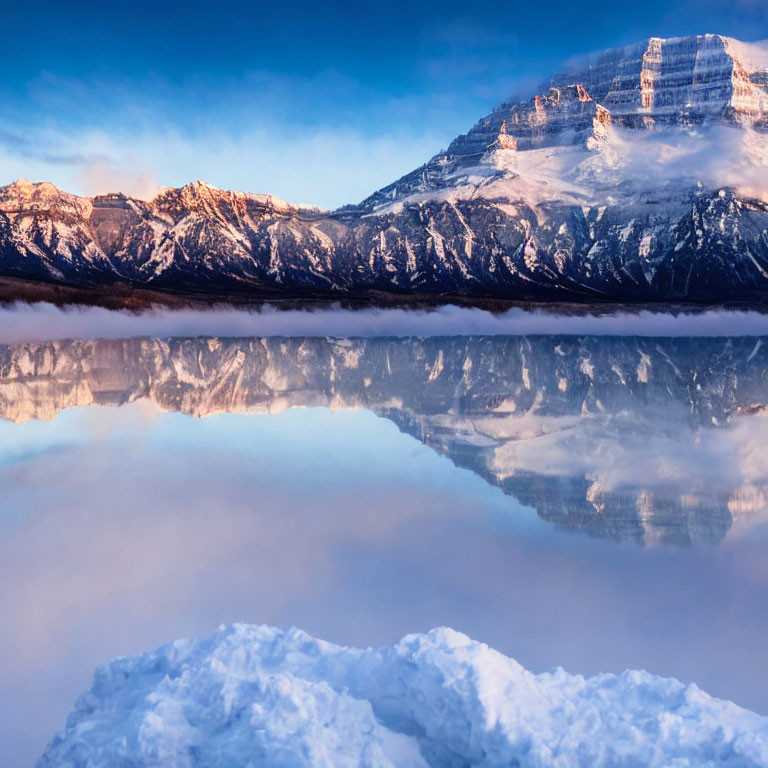 Snowy Mountain Landscape Reflected in Still Lake