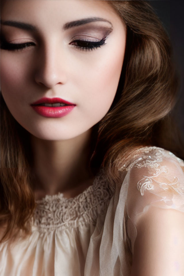 Detailed makeup look with winged eyeliner and red lipstick on woman's face