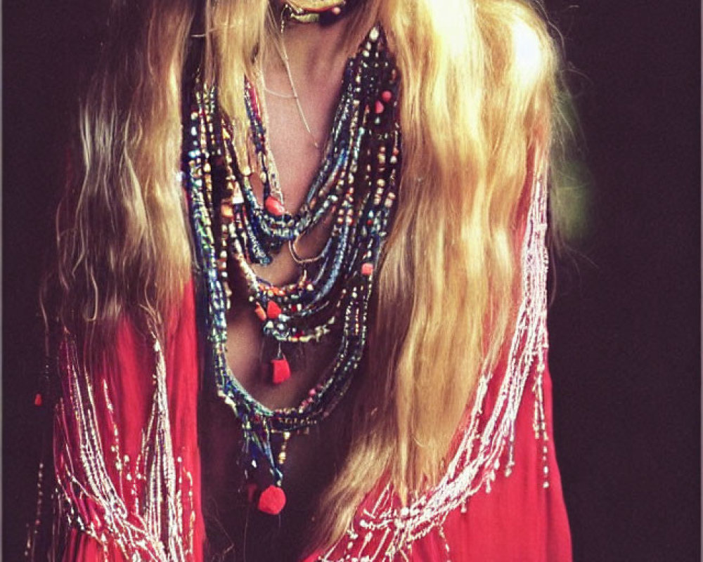 Blonde woman in red boho blouse with layered necklaces