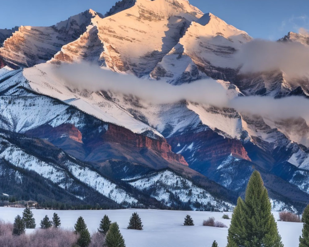 Majestic snow-covered mountain range in twilight with clouds and evergreen trees