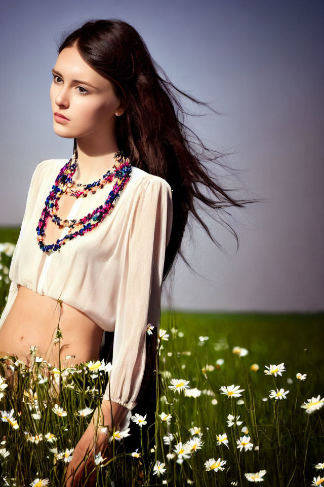 Woman in White Blouse Standing in Daisy Field with Beaded Necklace