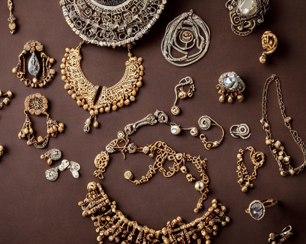 Luxurious Gold Jewelry with Gemstones on Dark Brown Background