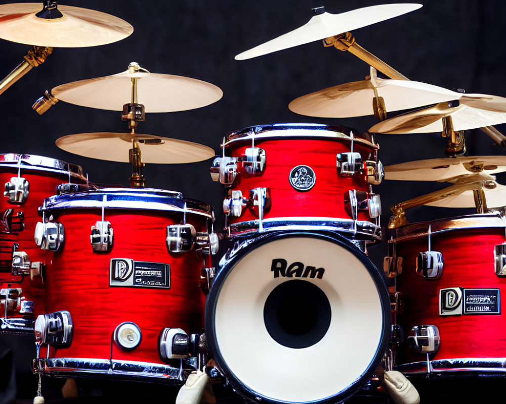 Vibrant red drum set with various cymbals on dark background