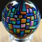 Multicolored bubble glass paperweight resembling cosmic galaxy