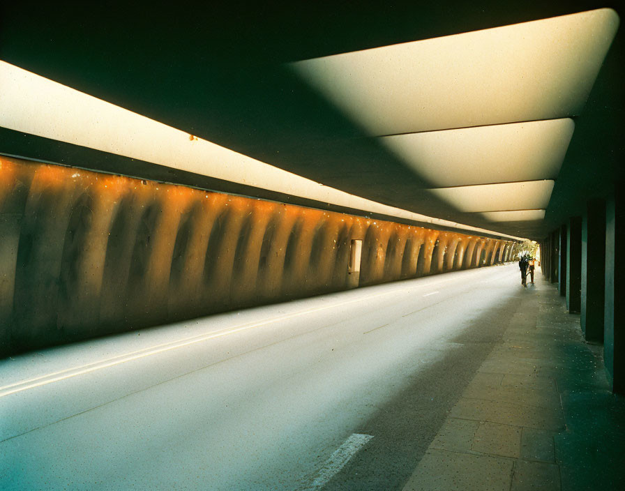 Pedestrian and Cyclist in Modern Tunnel with Geometric Lighting