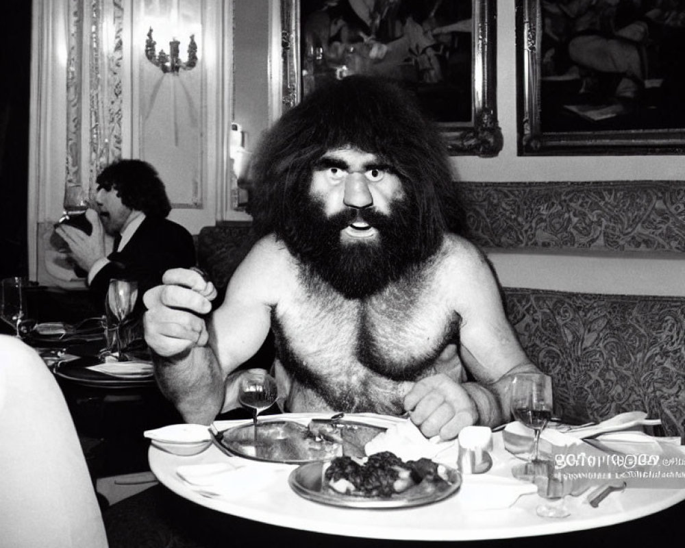 Bearded man in caveman attire dining in elegant room