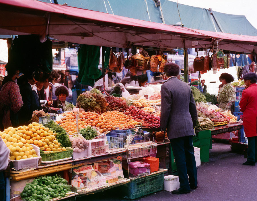 Vibrant outdoor market with colorful fruit and vegetable stalls