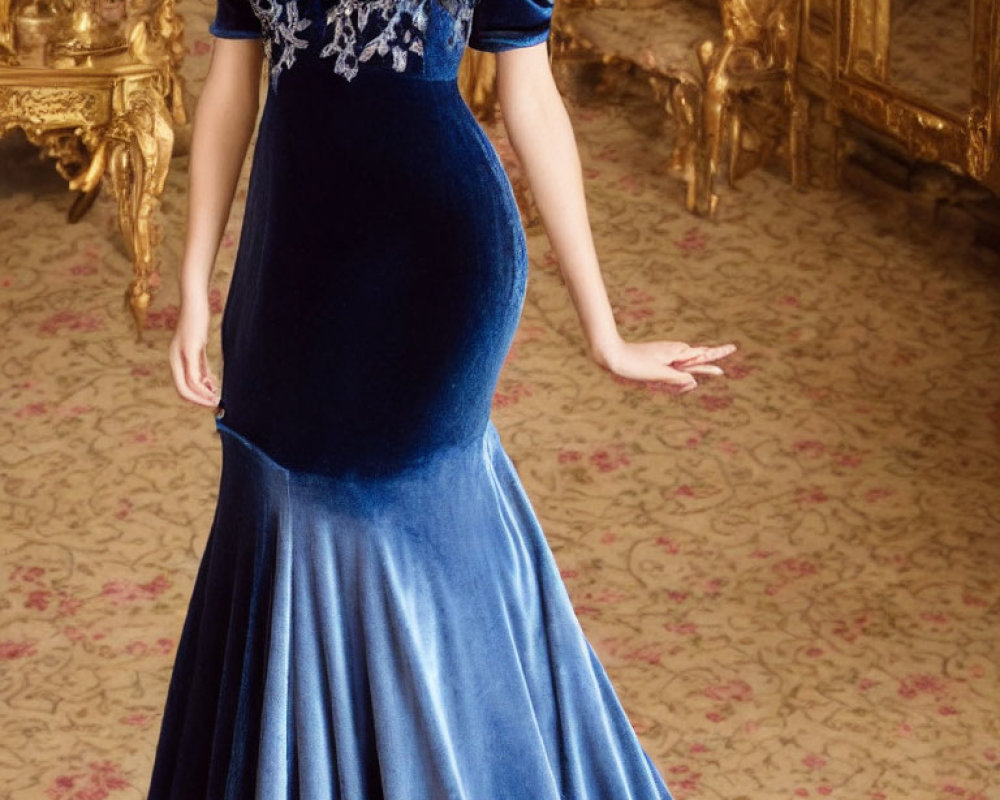 Woman in Dark Blue Velvet Dress in Luxurious Room with Golden Decorations
