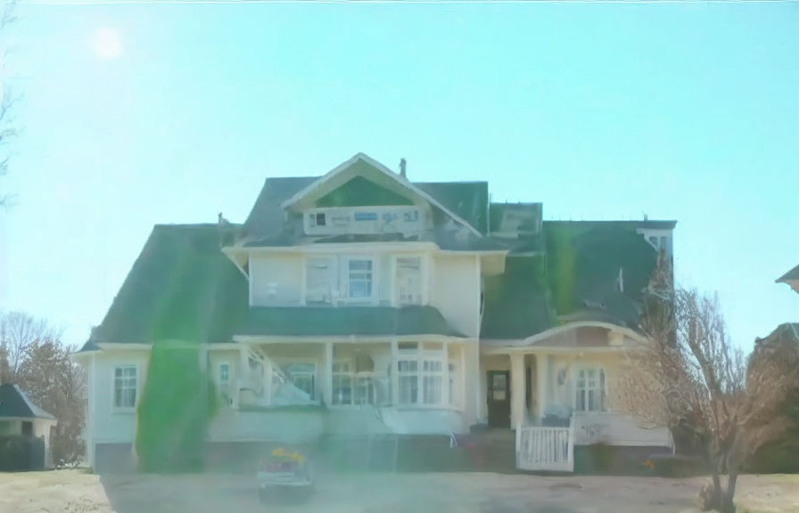 Blurred Image of Large Two-Story House with Porch