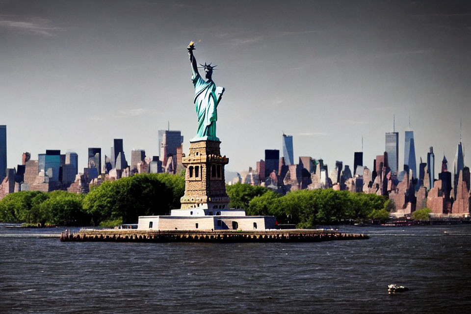 Iconic Statue of Liberty with NYC Skyline and Boat in Background