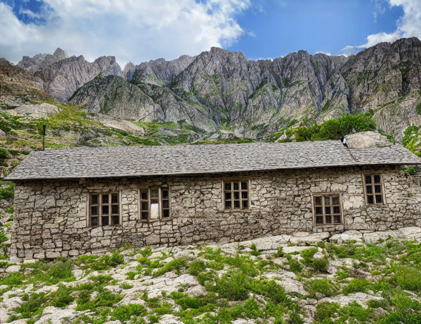 Stone Cottage with Slate Roof in Mountainous Grassland