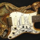 Steampunk-themed electric guitar with intricate metallic designs and clockwork elements