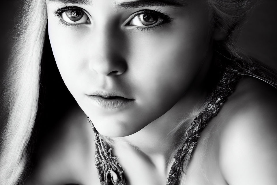 Monochrome portrait of young woman with intense eyes and serious expression