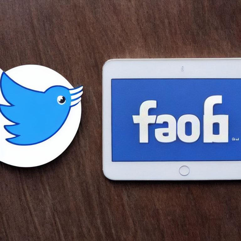 Social media logo stickers on tablet: Twitter bird next to flipped Facebook logo "faof".