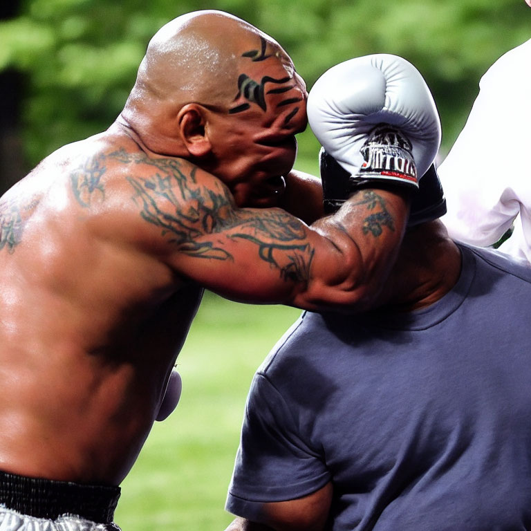 Muscular men boxing with head guard punch.
