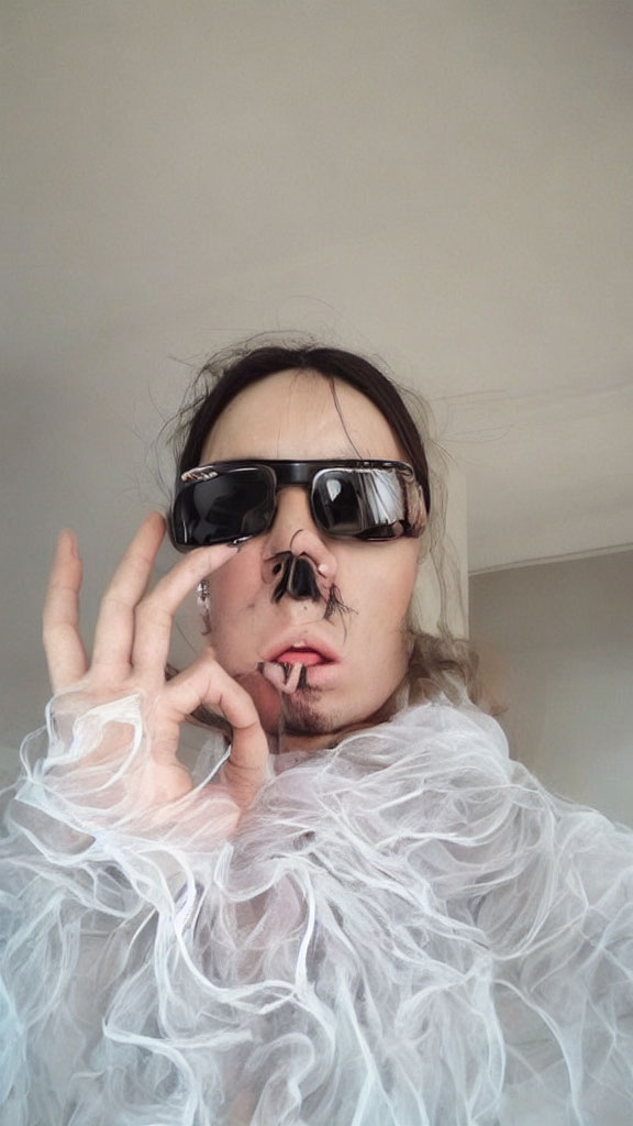 Person in Oversized Sunglasses and White Frilly Scarf Making Hand Gesture