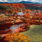 Serpentine river and fiery autumn foliage in isolated landscape
