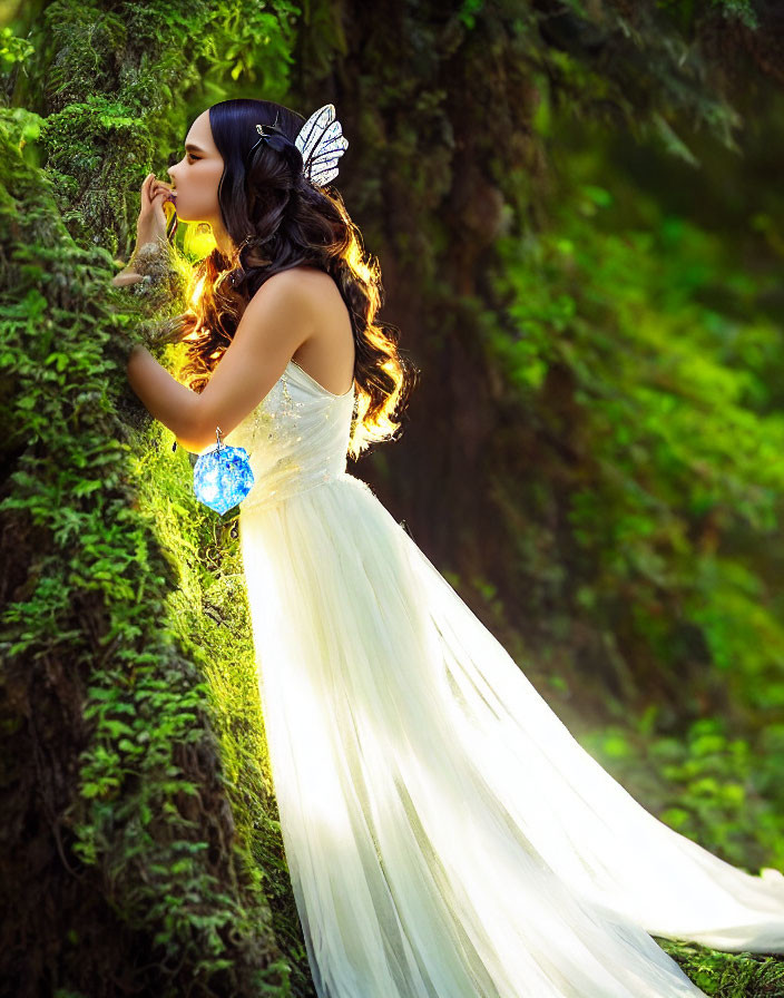 Woman in white dress with fairy wings holding blue orb in mossy forest.