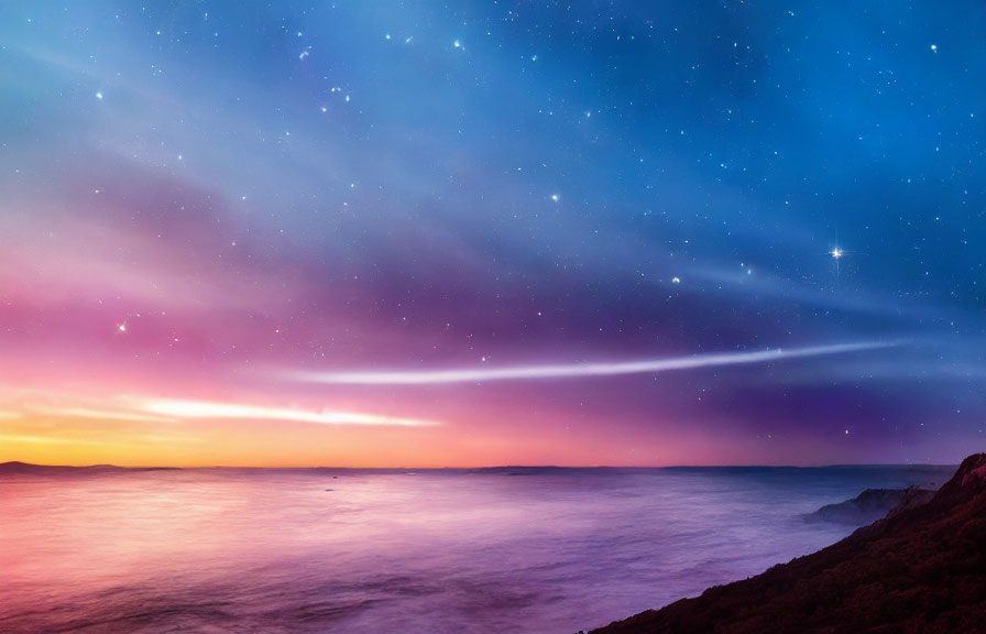 Twilight sky with stars over tranquil ocean on rocky coastline