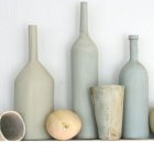Elegant Ceramic Vases with Olives and Citrus on Pale Background