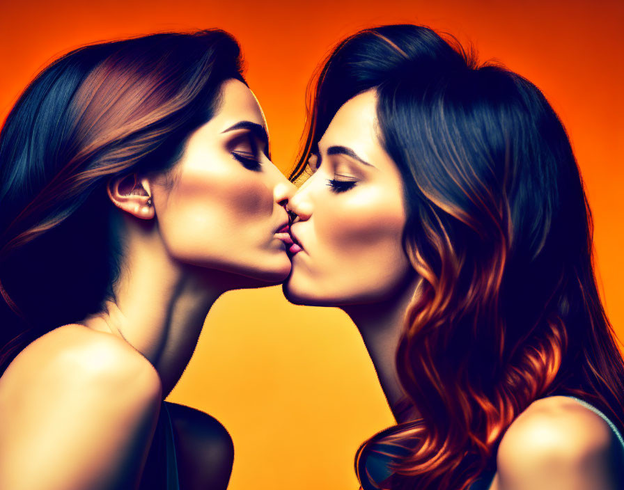 Two women kissing with flowing hair on orange background