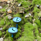 Miniature steampunk landscape with moss-covered hills and metallic structures