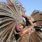 Vibrant carnival costumes with feathered headdresses and masks
