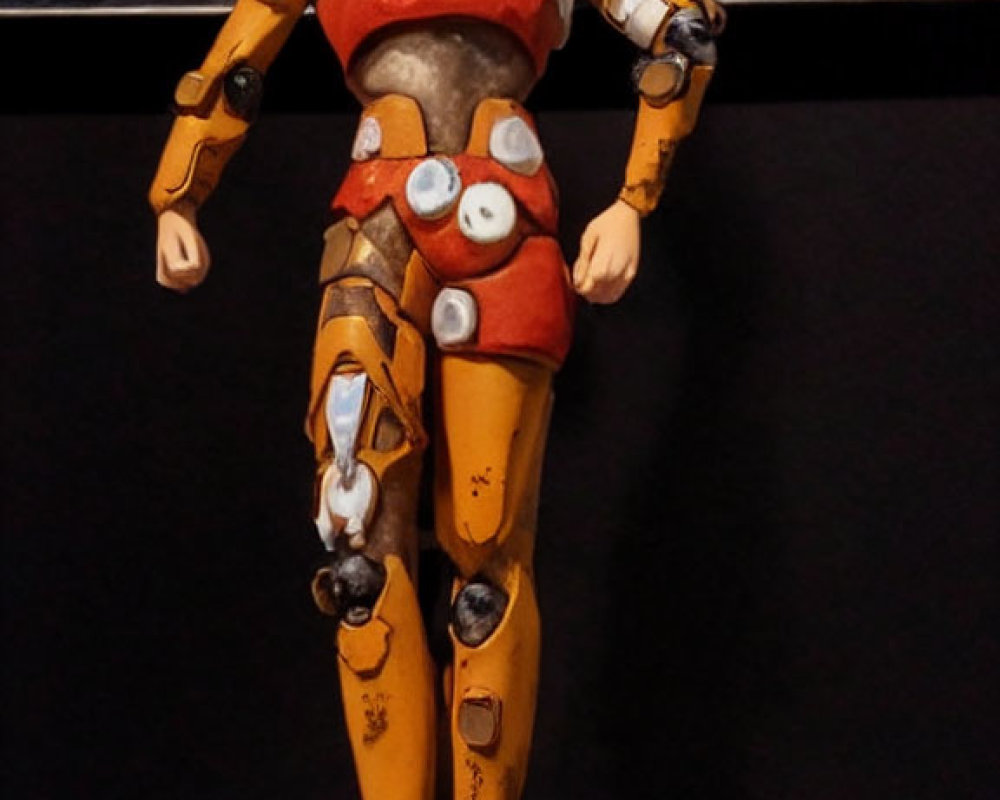 Blue-haired anime figurine in yellow-orange armor next to "MOSPEADA" sign